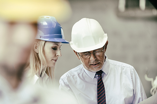Engineers looking at blueprints
